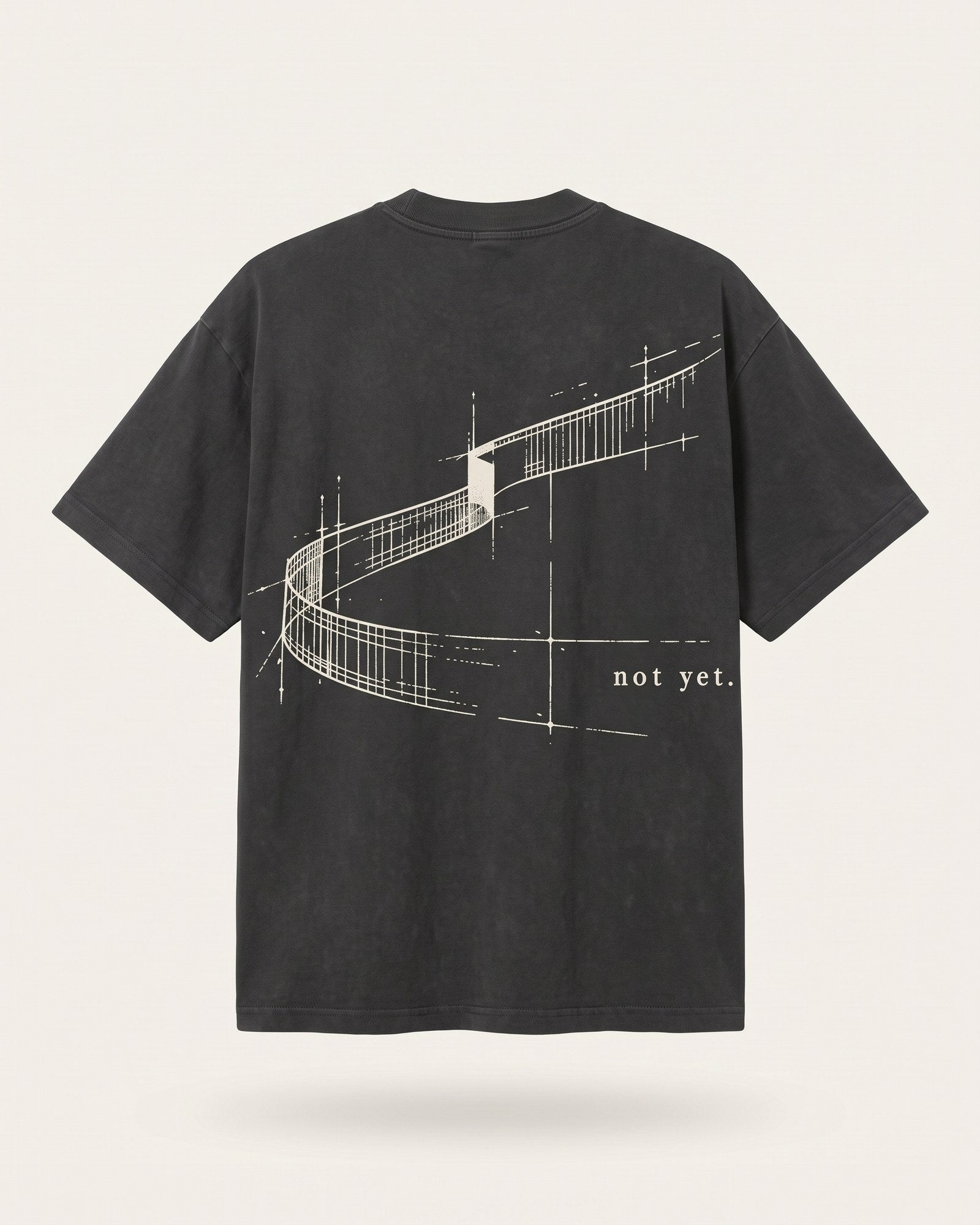 faded black oversized heavy tee, back: a long curving ribbon of road, not yet.